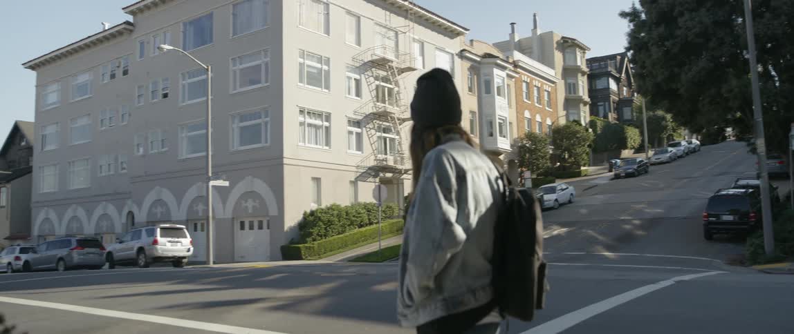 A woman walks across the street
