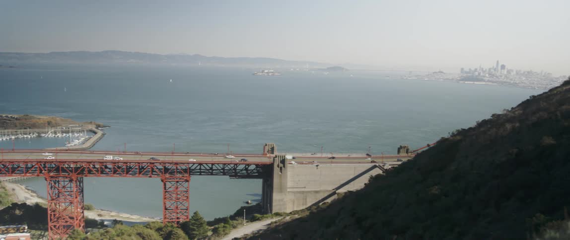 Cars drive over a bridge