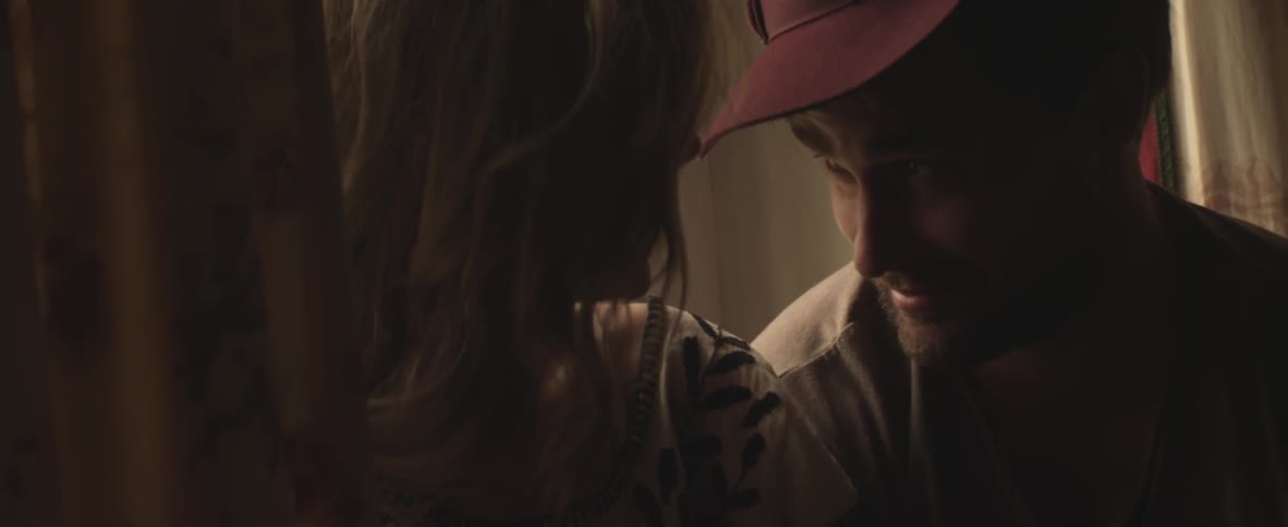 Woman takes off her hat and puts it on a man