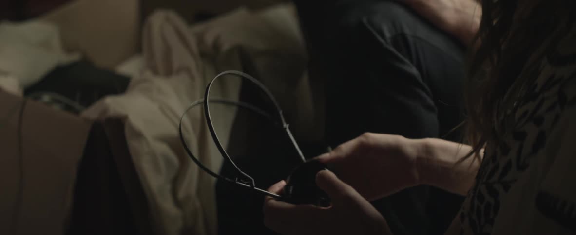 Person holding and examining headphones