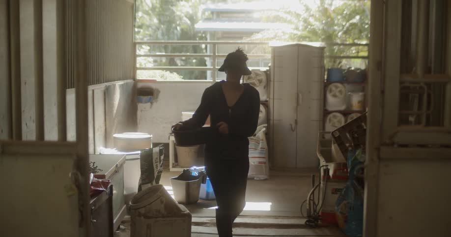 Woman picks up a large pan and walks away