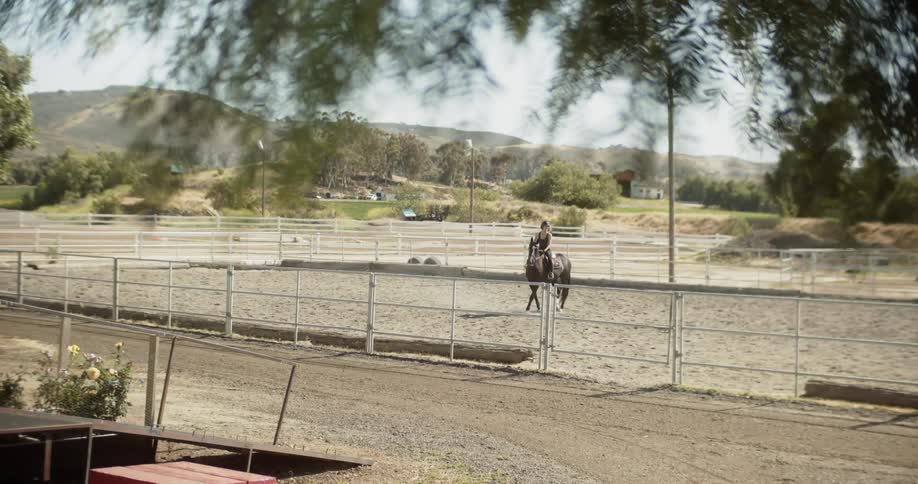 A woman rides on a horse