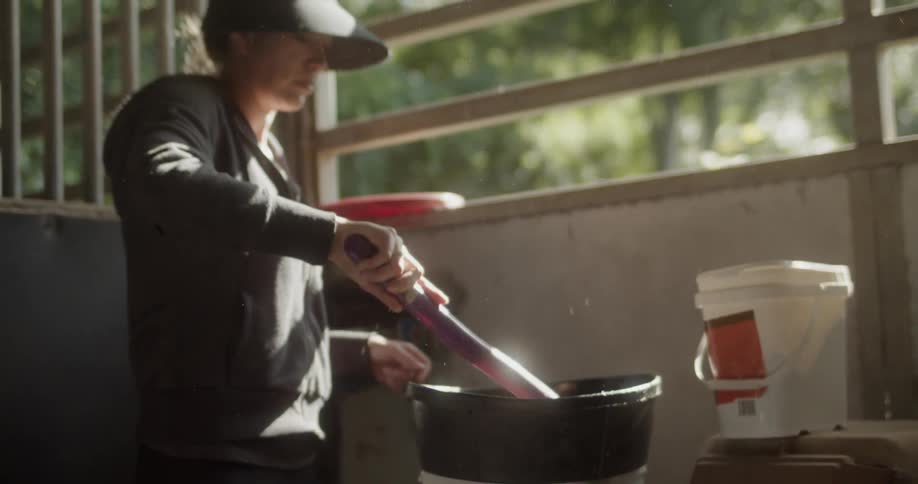 Woman stirs a mixture in a bowl