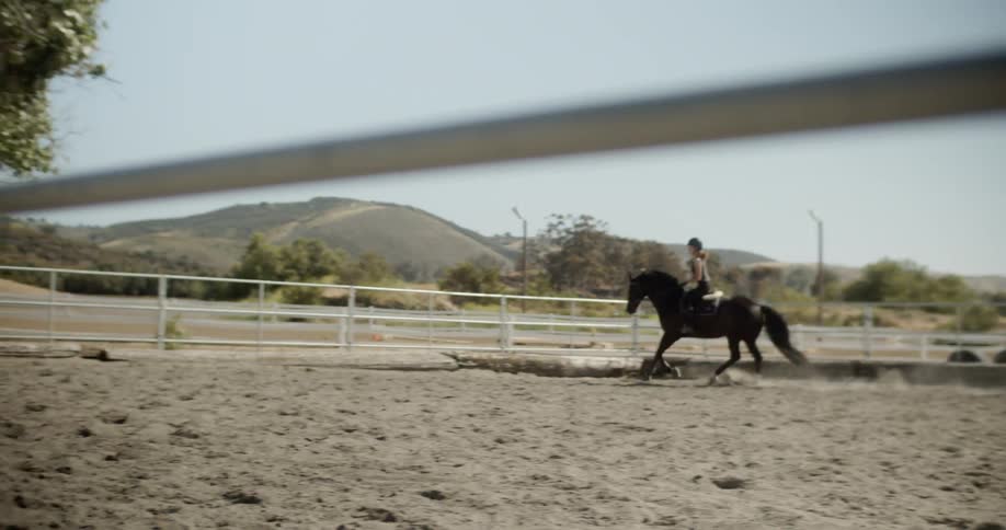 Woman rides a horse on a ranch