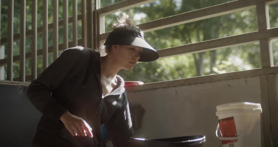 A woman fills a basket and walks off with it