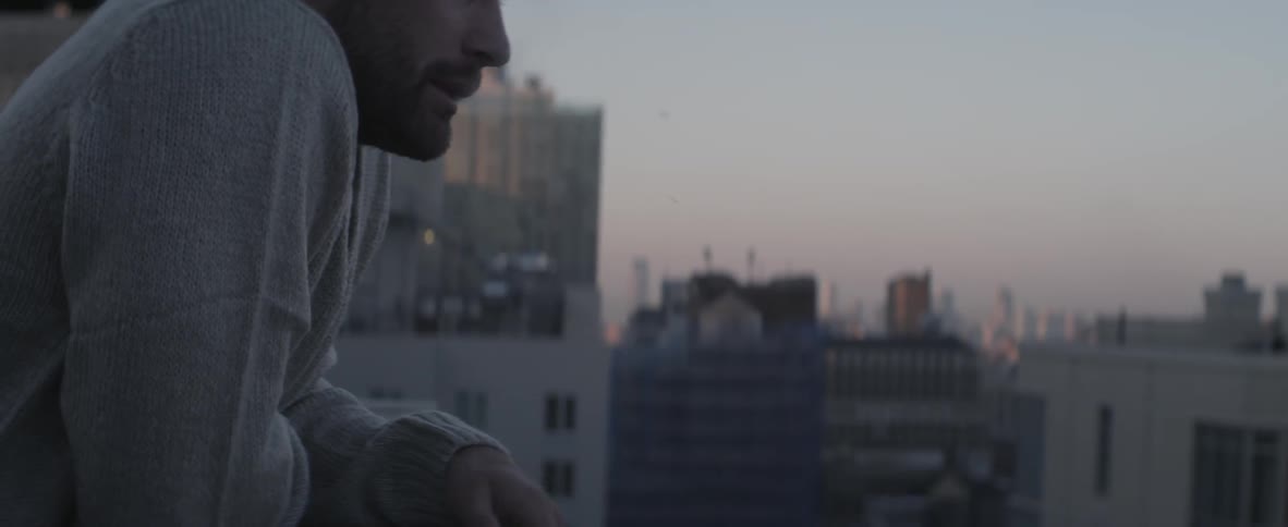 A man is smoking a cigarette and relaxing in an urban city