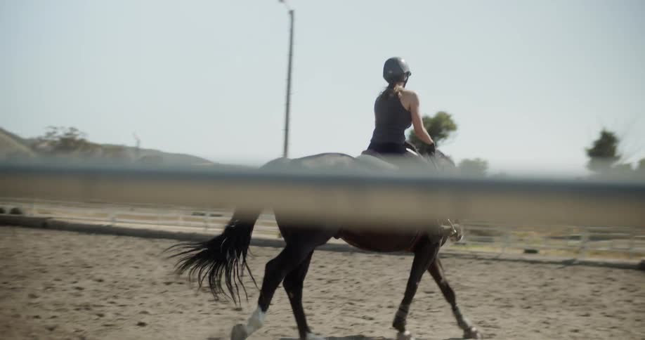Woman rides a horse on a ranch
