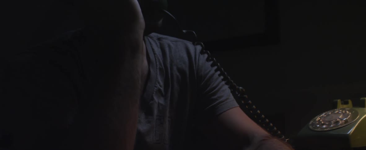 A man wakes up to answer the telephone