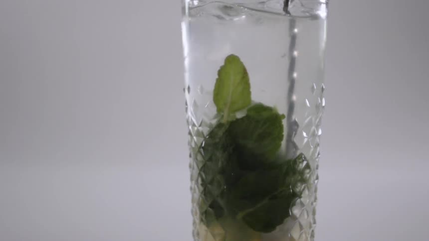 A drink is stirred in a glass