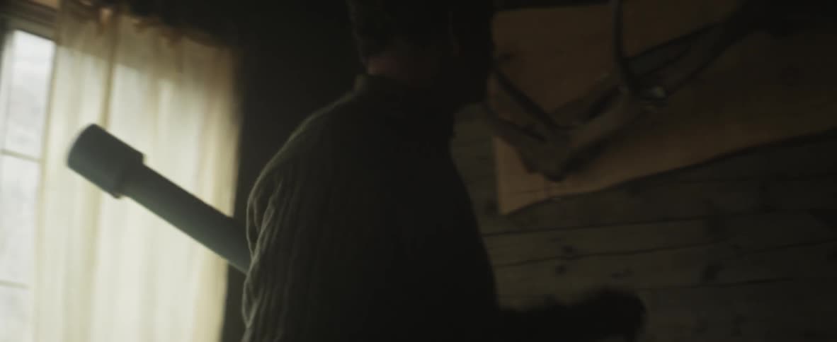 A person holding a curtain open