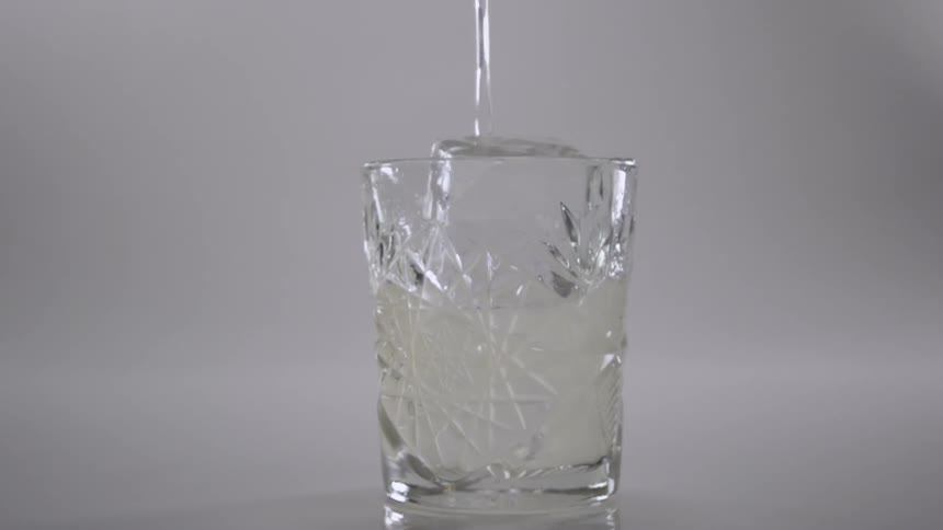 A beverage is poured into a glass