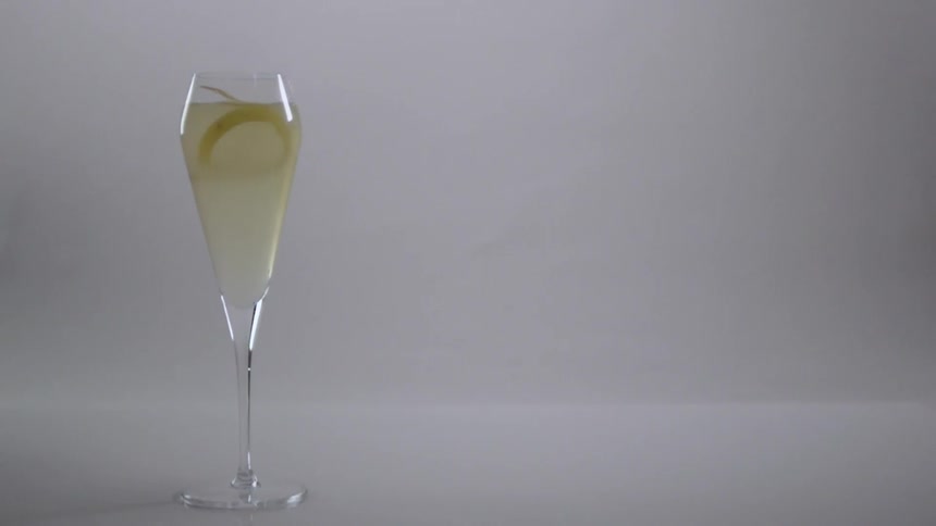 A lemon peel is dropped in the drink