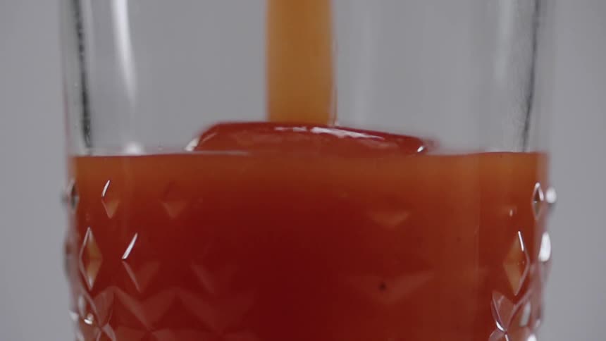 Ice and a drink is poured into the glass
