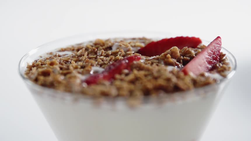 A strawberry falls in the parfait glass
