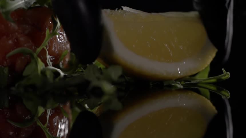 A person places a lemon on the counter