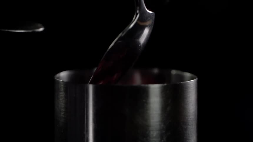 Food gets scraped from a ladle into a pot