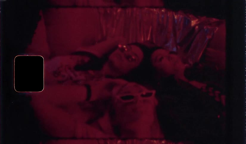 Three women are resting on the bed