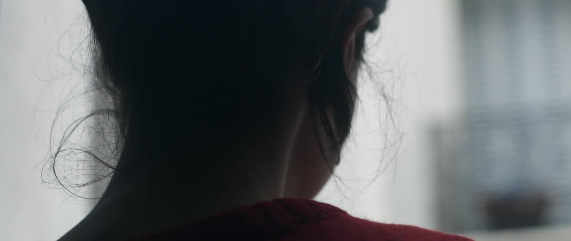 Woman blinks her eyes as she looks around a room
