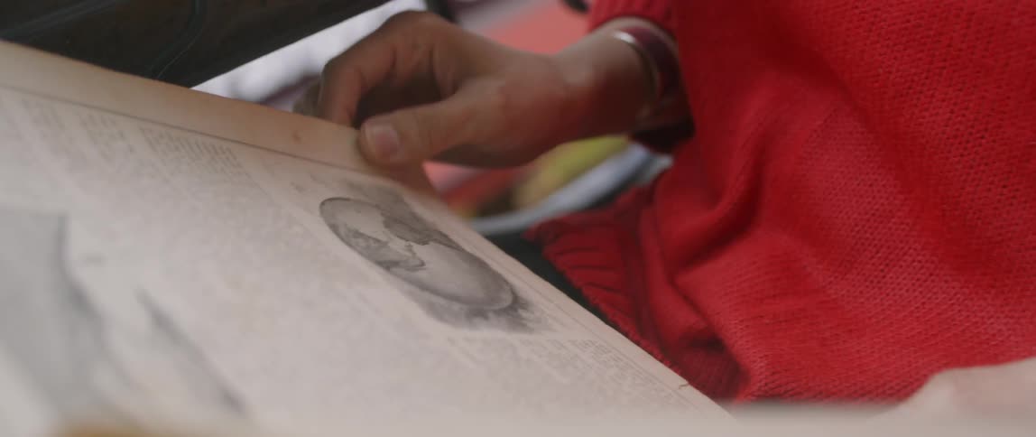 Person gets read to turn the page of a book