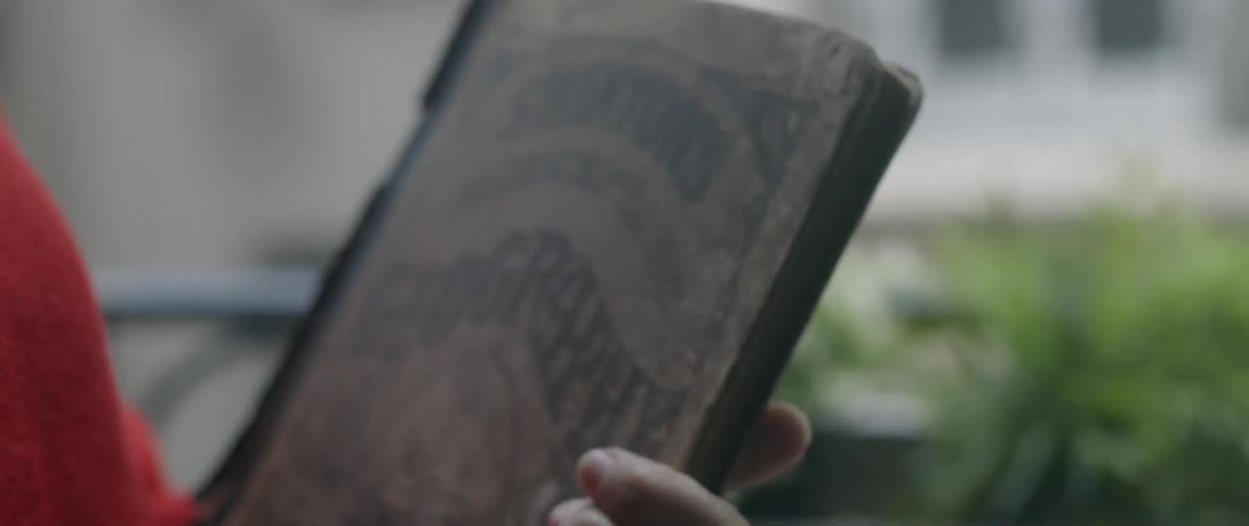 A woman holds an old book