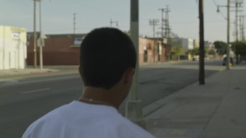 A man walks down the sidewalk of the town