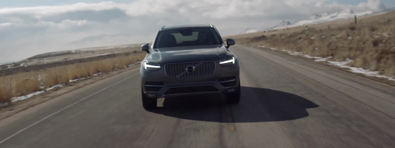 A man drives on a rural road
