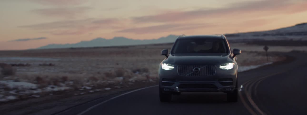 Person driving on a country road at sunset