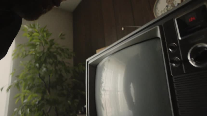 Man turns on an old television
