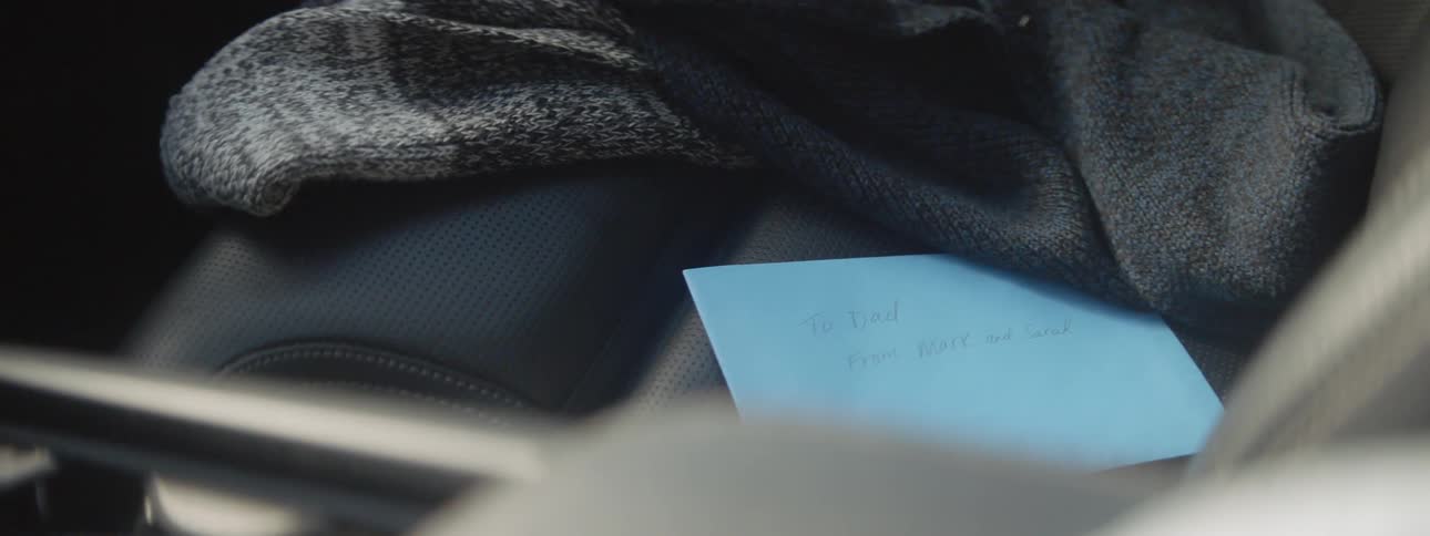 Greeting card sits on passenger seat of moving car