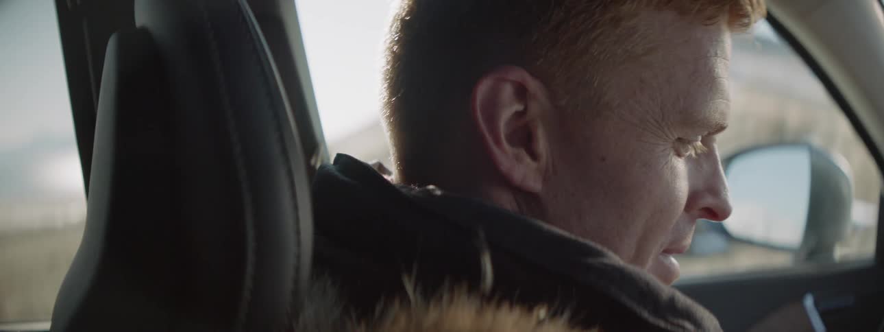 Man talks while sitting in a car