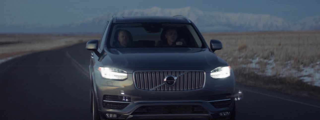 Two people are in the car traveling on the road