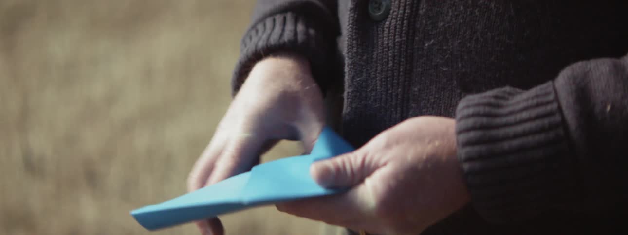 Person hands card to another person who opens it