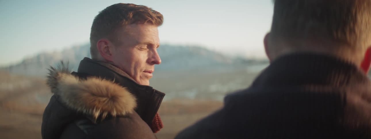 A man looks to his side talking with someone