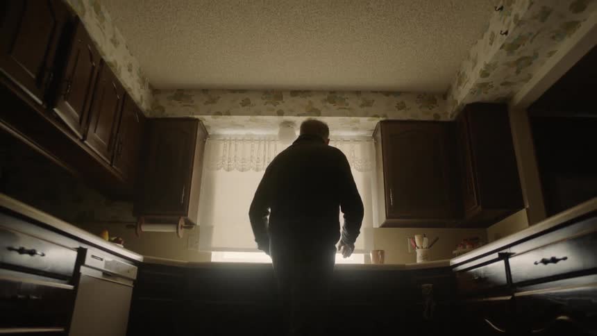 Man stands in front of a kitchen sink