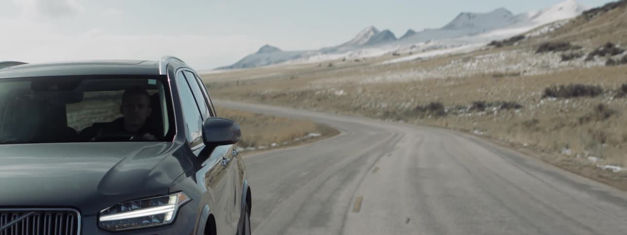 Man drives a volvo on a rural road