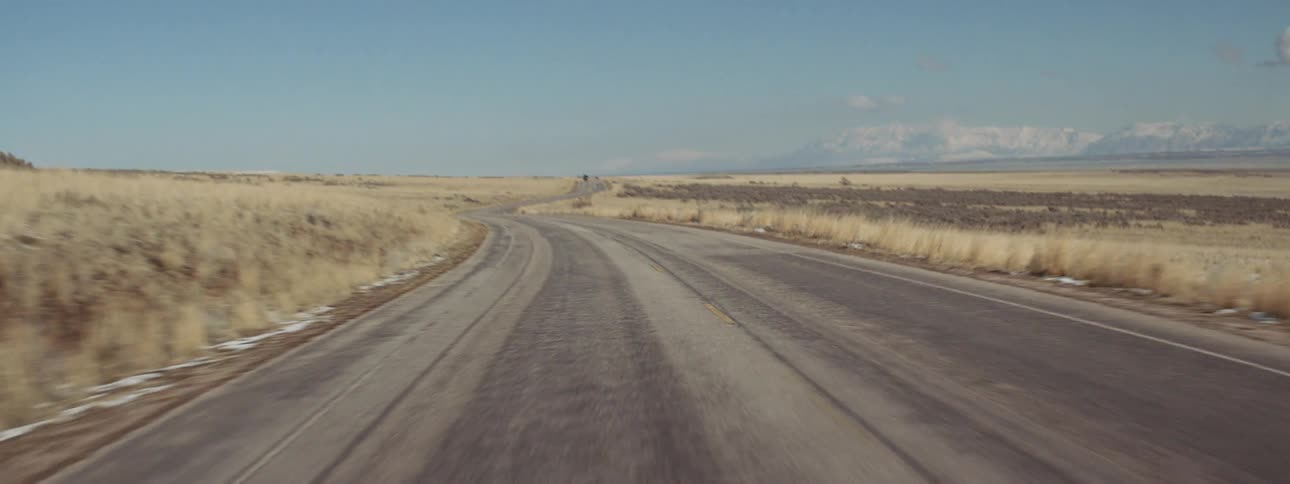 A car travels on a rural road