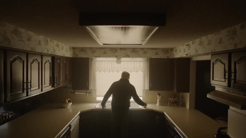Man drinks coffee in a kitchen