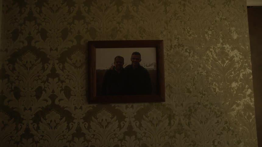 A photograph hangs on a wall
