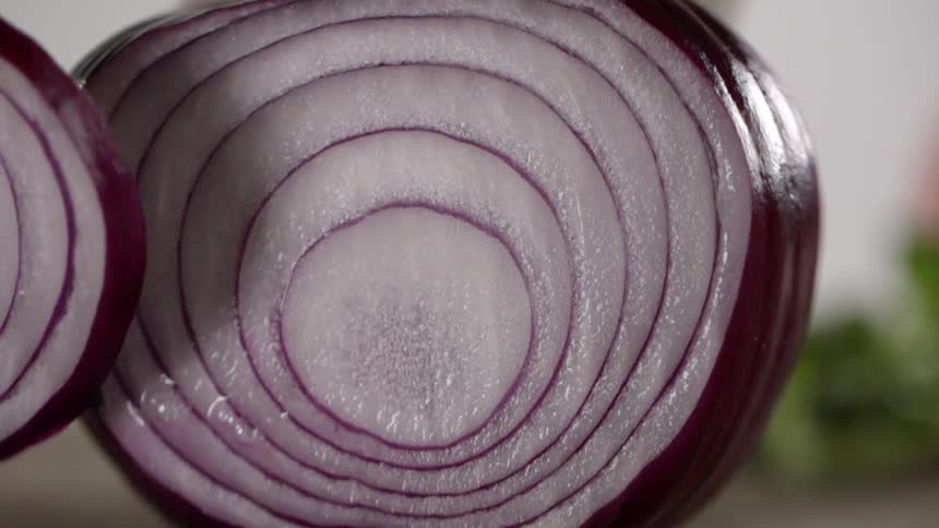 A person is slicing an onion