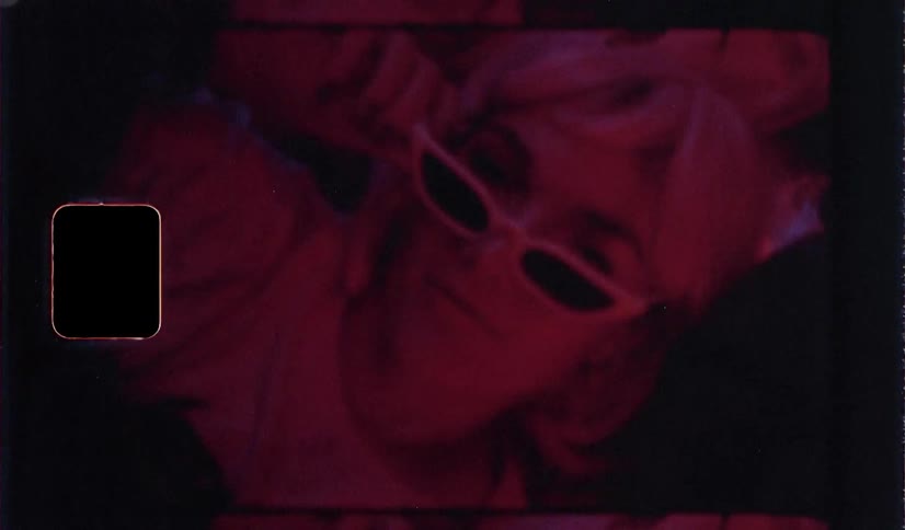 A woman lays back wearing sunglasses