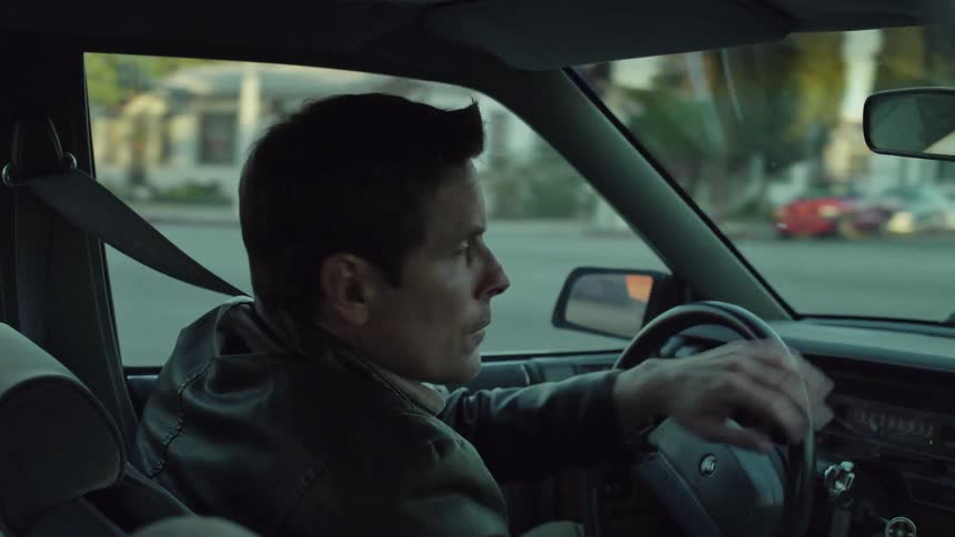 Man drives a car on a town street