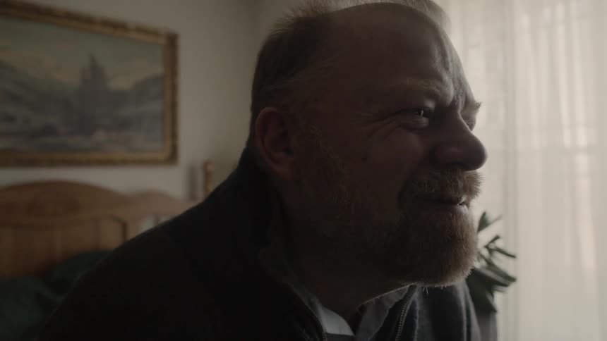 A man is amused by something he is watching