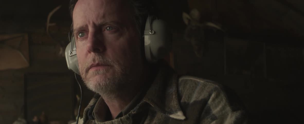Man listening to old radio headphones intently