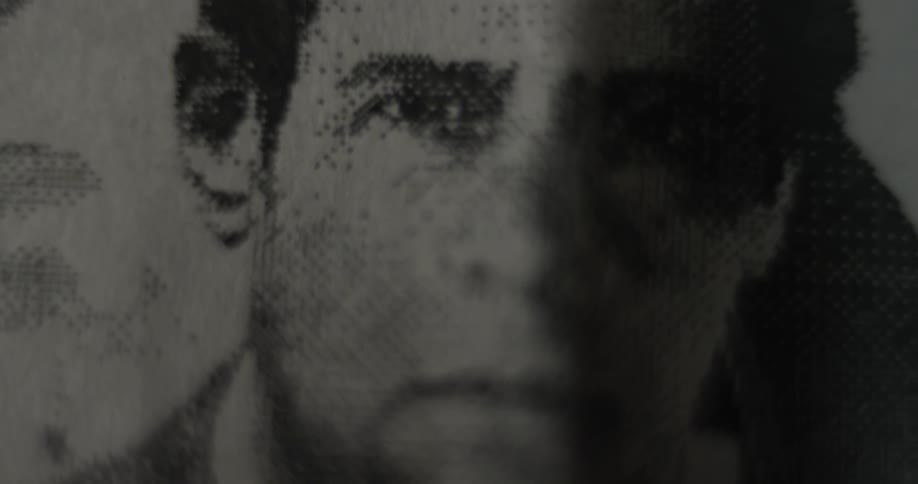 A mans face is printed on the paper