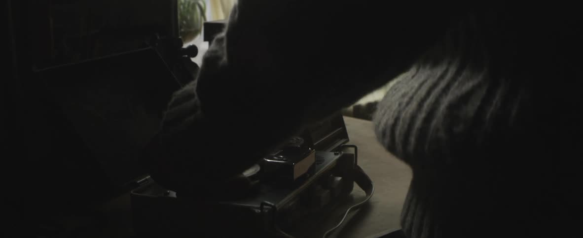 A person is using an old tape recorder