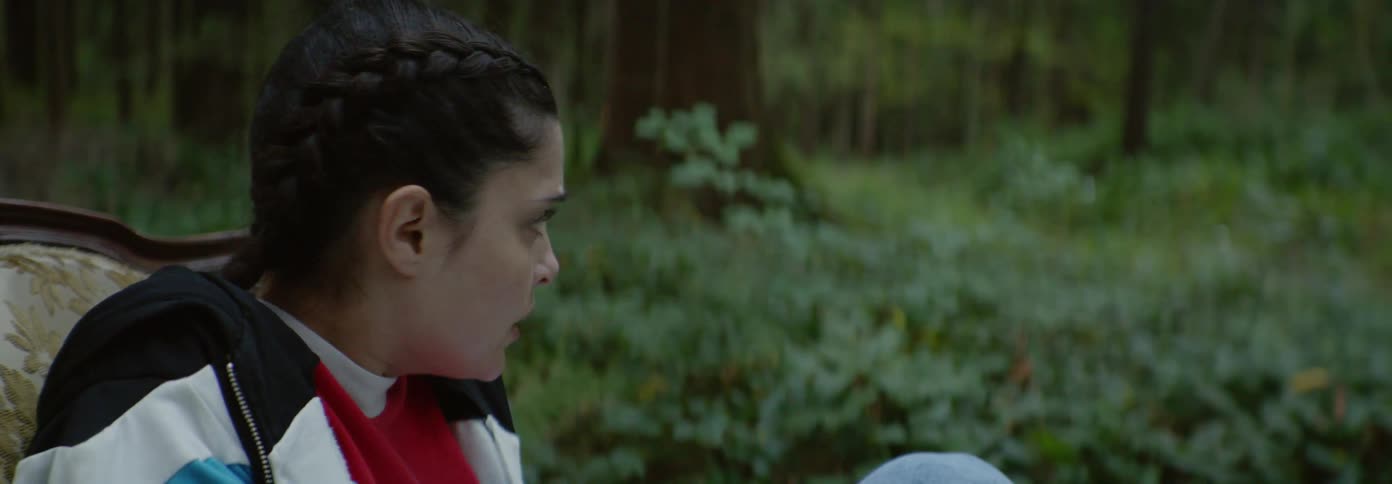 A girl looks around the forest