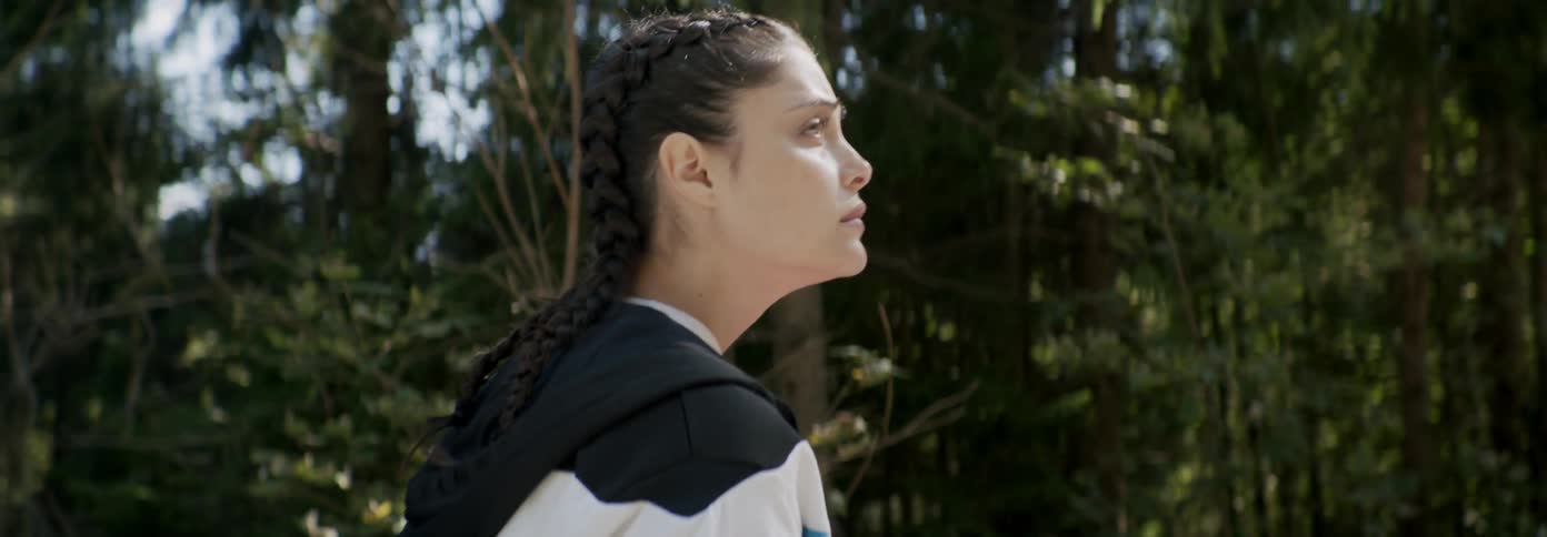 Woman looks worried while walking in a forest