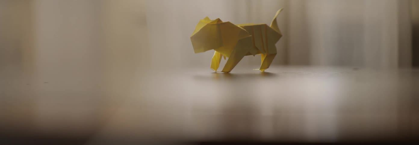 A paper dog sculpture stands