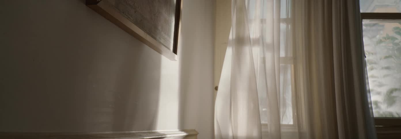 Wind blows the white curtain on a sunny day