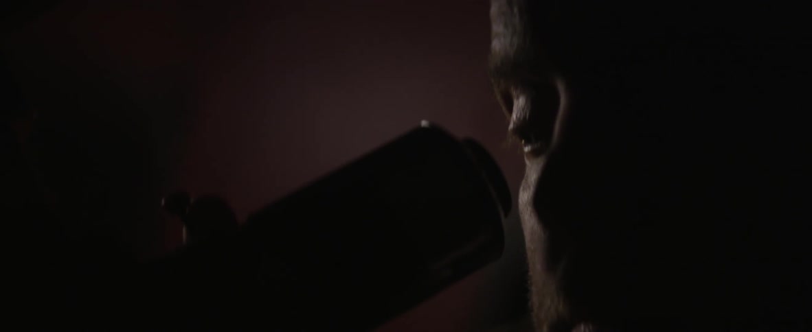 A man looks through his telescope